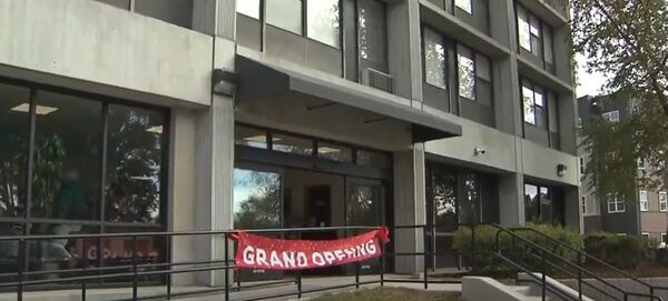 Front of a building with a sign that reads Grand Opening.