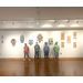 Four children stand in front of their art work.