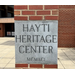 A brick and concrete post that reads Hayti Heritage Center.