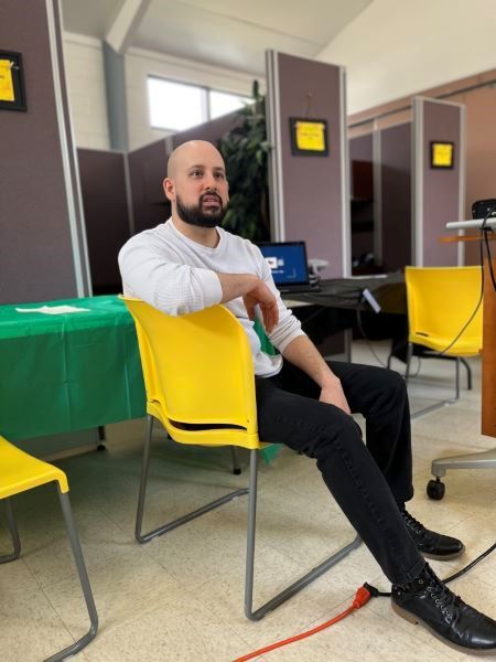 A man sitting in a yellow chair.