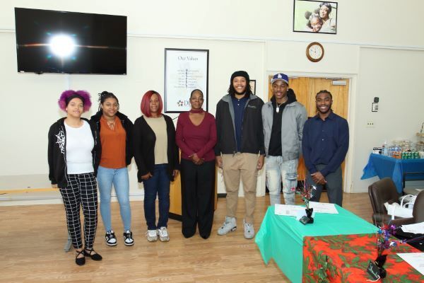 A group of individuals smile for a photo.