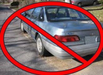A car without a license plate with a red circle and a line going through it over top.