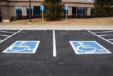 Two handicap parking spots in front of a building.