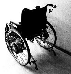 A view of a wheelchair from the back.