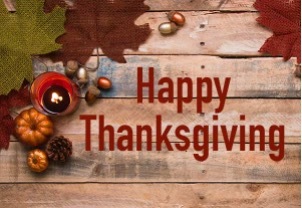 Happy Thanksgiving. Pumpkins and leaves on a wooden table.