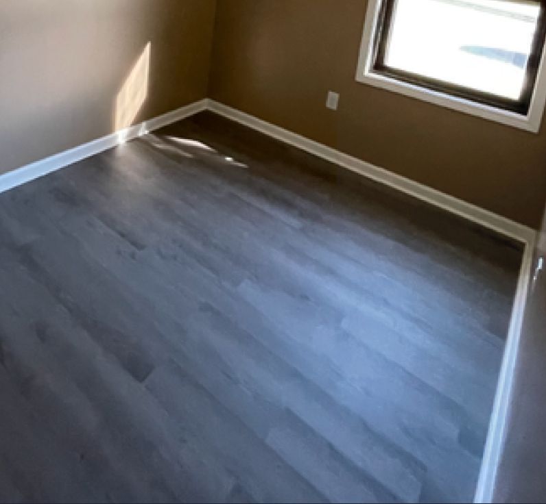 A bedroom with new hardwood floors.