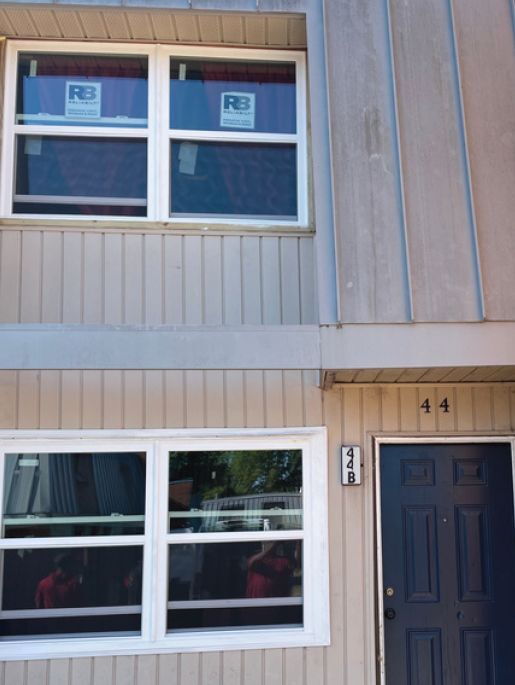 Outside view of two window sills with new modern and energy-efficient windows installed..
