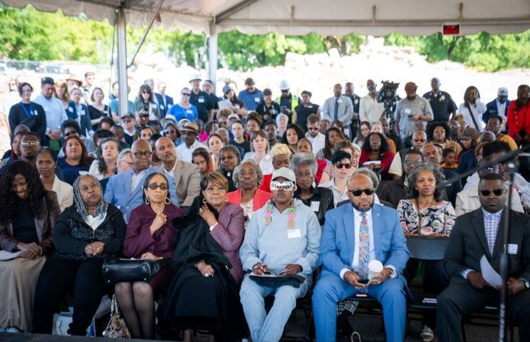 An audience listening to a speaker on stage.