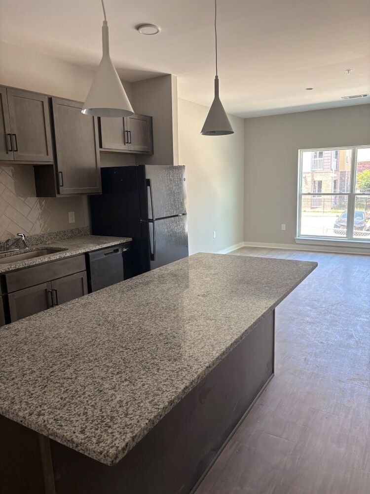Interior view of the kitchen and living room space at the Converge Senior Living apartments.