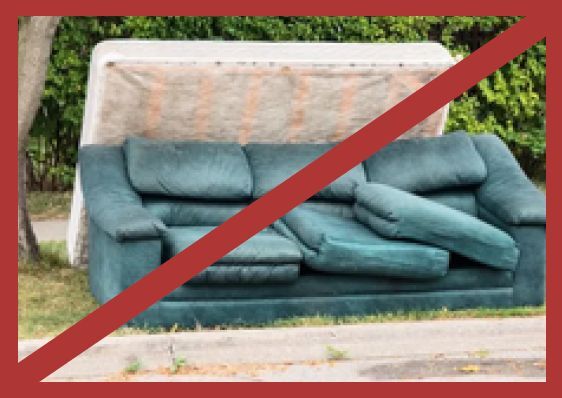 A couch and a mattress outside on a curb with a red slash going through the picture.