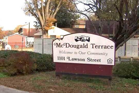 A sign that reads McDougald Terrace Welcome to Our Community 1101 Lawson Street