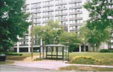 JJ Henderson apartments sit just off the highway, next to a bus stop.
