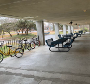 Picnic tables and bikes in an outside patio area.