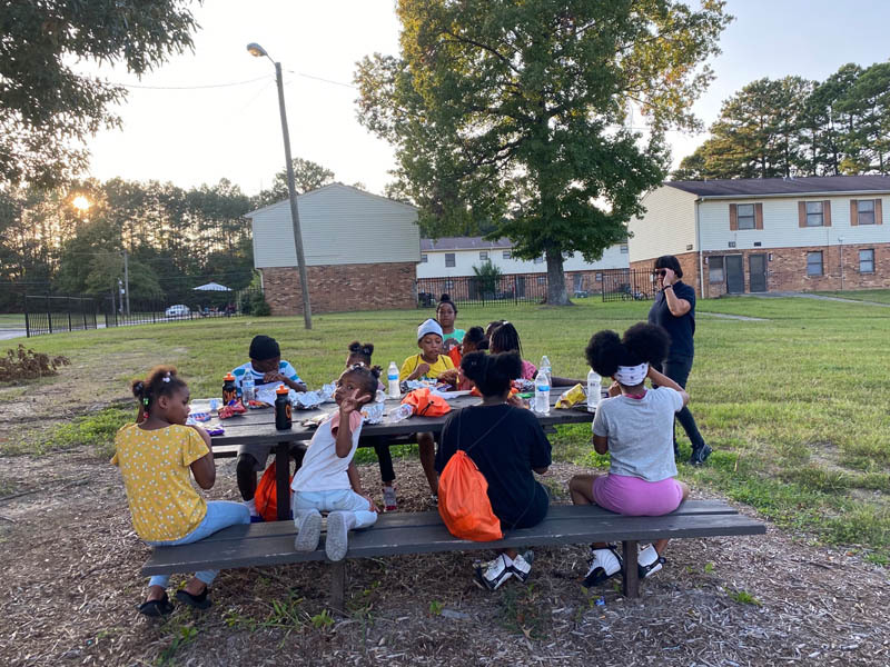 Kids eating at a picnic table.