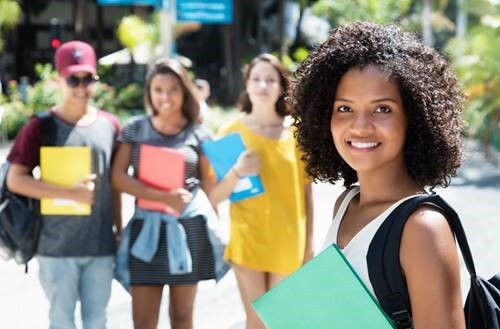 A group of students standing outside on campus.