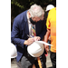 A man signing a hard hat.