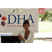 Lady posing in front of DHA sign.