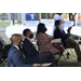 two ladies and two men in second row listening to speech