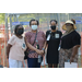 four masked ladies outside of tent 