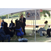 male speaker addressing crowd in tent