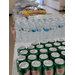 Water bottles and soda cans lined up on a table