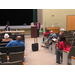 Audience listening to a man speak