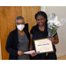 Two women holding an academic award