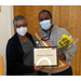 Woman standing together holding an academic award