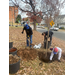 Three men helping plant a tree