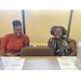 two woman sitting at a desk with awards