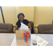 woman sitting at a desk with a gift bag