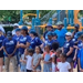 A group of people standing in front of a play ground