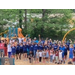 A group of individuals holding their hands up at a park