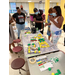 Individuals gathered around a table with activities. 