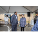 Two people talking to each other under the event tent