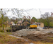 An Excavator dumping materials into a truck