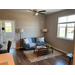 A living room with furniture and hard wood floors.