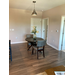 A dining room with a wooden dining room table.