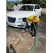 Two boys giving a car a car wash.