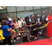 A group of individuals cutting a ribbon. 