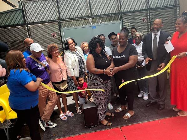1.jpg A group of individuals cutting a ribbon.