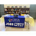 A table with artwork that reads: DHA Durham Housing Authority - Jobs Plus.
