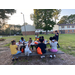 A group of kids eating at a picnic table.