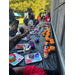 A group of kids painting small pumpkins.