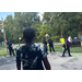 Kids standing next to police officers.