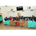 Various individuals sitting at a table speaking with each other.
