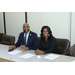 A man in a suit and a woman sitting side by side.