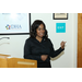 A woman standing behind a podium making hand gestures. 