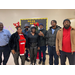 A group of people standing in front of a Christmas tree.