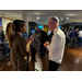 A woman making hand gestures while talking to a man.